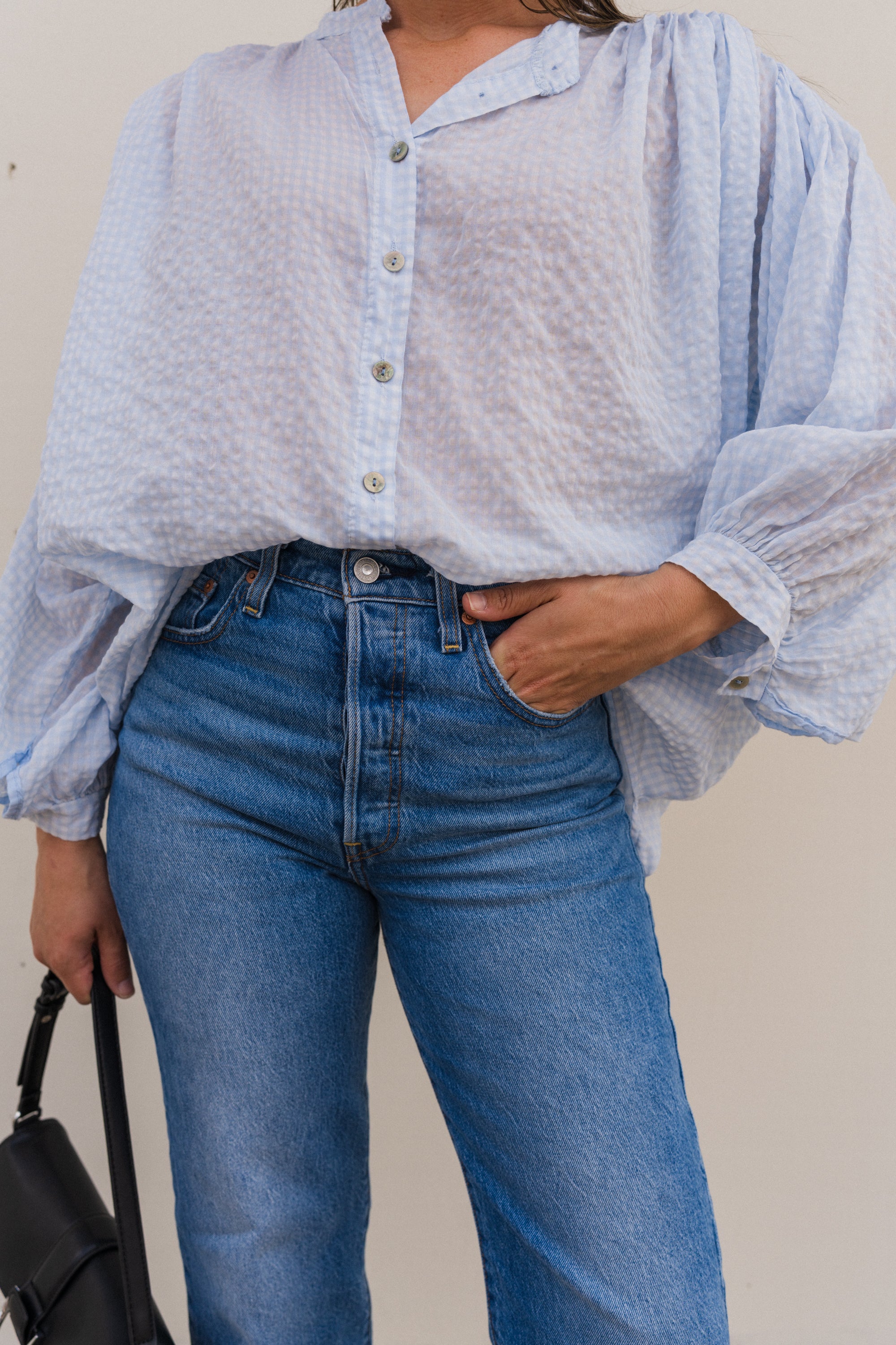 Lightweight blue cotton gingham blouse for women with button front and relaxed fit