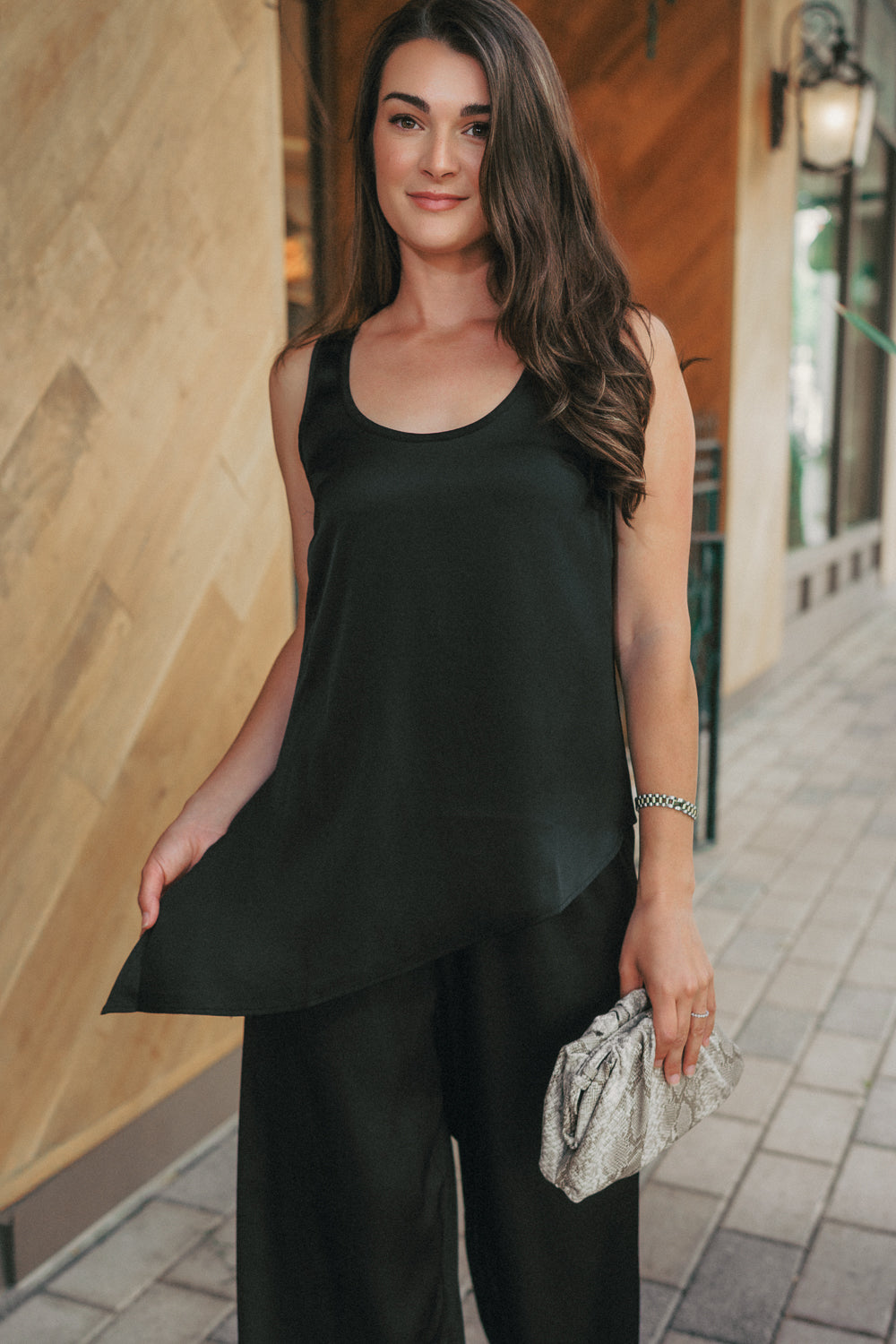Chic black two-piece set with asymmetrical top and wide leg pants, perfect for travel, errands, or dinner.
